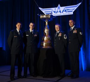 Members of Pedro 83 Flight, from left Capt. Vincent Powell, Capt. Brion Stroud, Chief Master Sgt. Norman Callahan, and Tech. Sgt. John Ballard, accept the Mackay Trophy on behalf of Pedro 83 Flight during a ceremony, in Arlington, Va., Nov. 12, 2013. The trophy is awarded for the "most meritorious flight of the year" by an Air Force person, persons or organization.(U.S. Air Force photo by Staff Sgt. Carlin Leslie)
